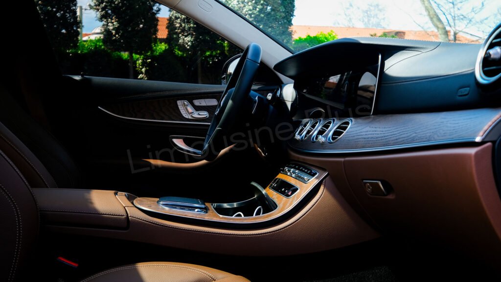 The luxurious interior of a Limousine Plus VIP vehicle, featuring rear-seat entertainment screens and premium leather seats for ultimate comfort.