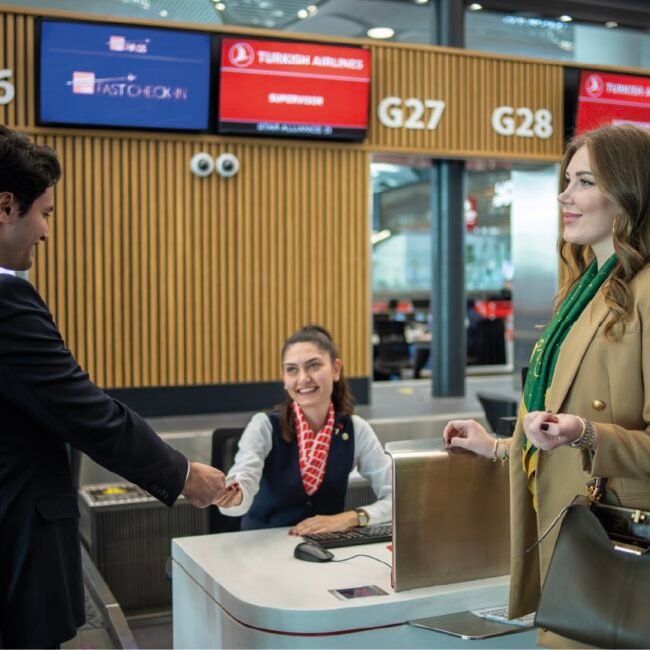 Business traveler receiving assistance at an airport check-in or information desk