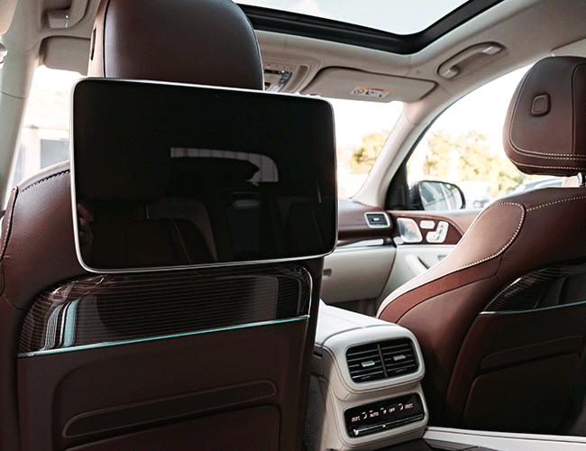 The luxurious interior of a Mercedes-Benz with rear-seat entertainment screens, showcasing the premium features of our Istanbul airport fast transfer service.