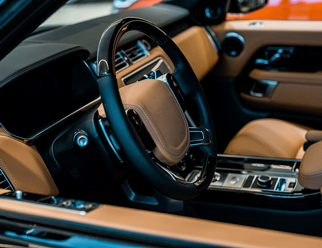 Interior view of a modern luxury SUV, showing the leather steering wheel and digital dashboard, part of the Istanbul VIP transfer fleet.