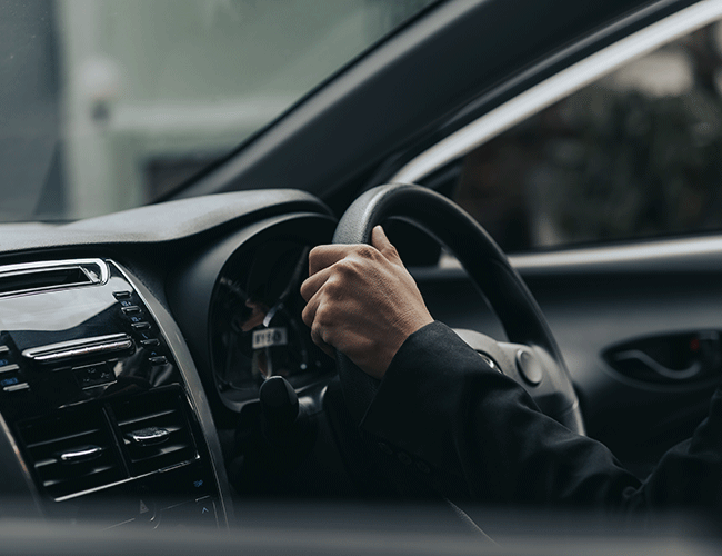 A professional chauffeur's hands on the steering wheel of a luxury car during a private transfer in Istanbul's Sultanahmet district.