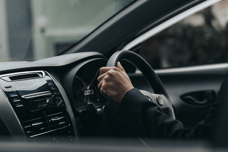 A professional chauffeur's hands on the steering wheel of a luxury car during a private transfer in Istanbul's Sultanahmet district.